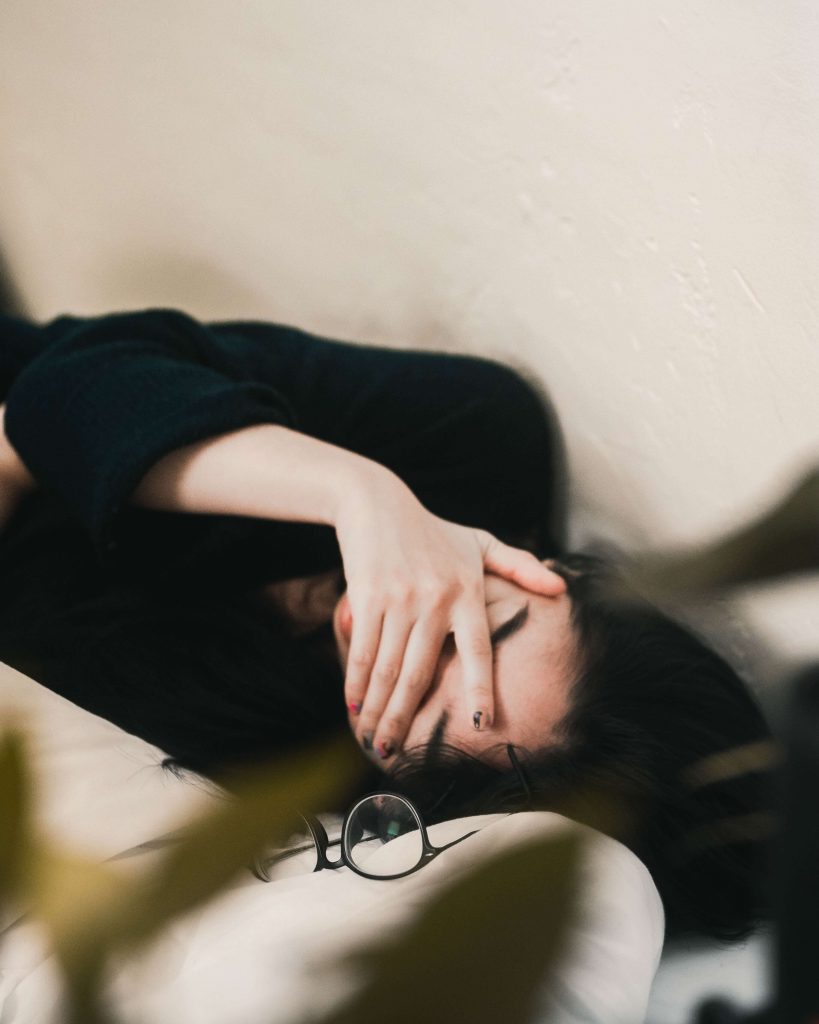 girl tired with glasses near her